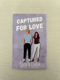 Captured for love signed paperback novelette by Nora Lane with character art & swag