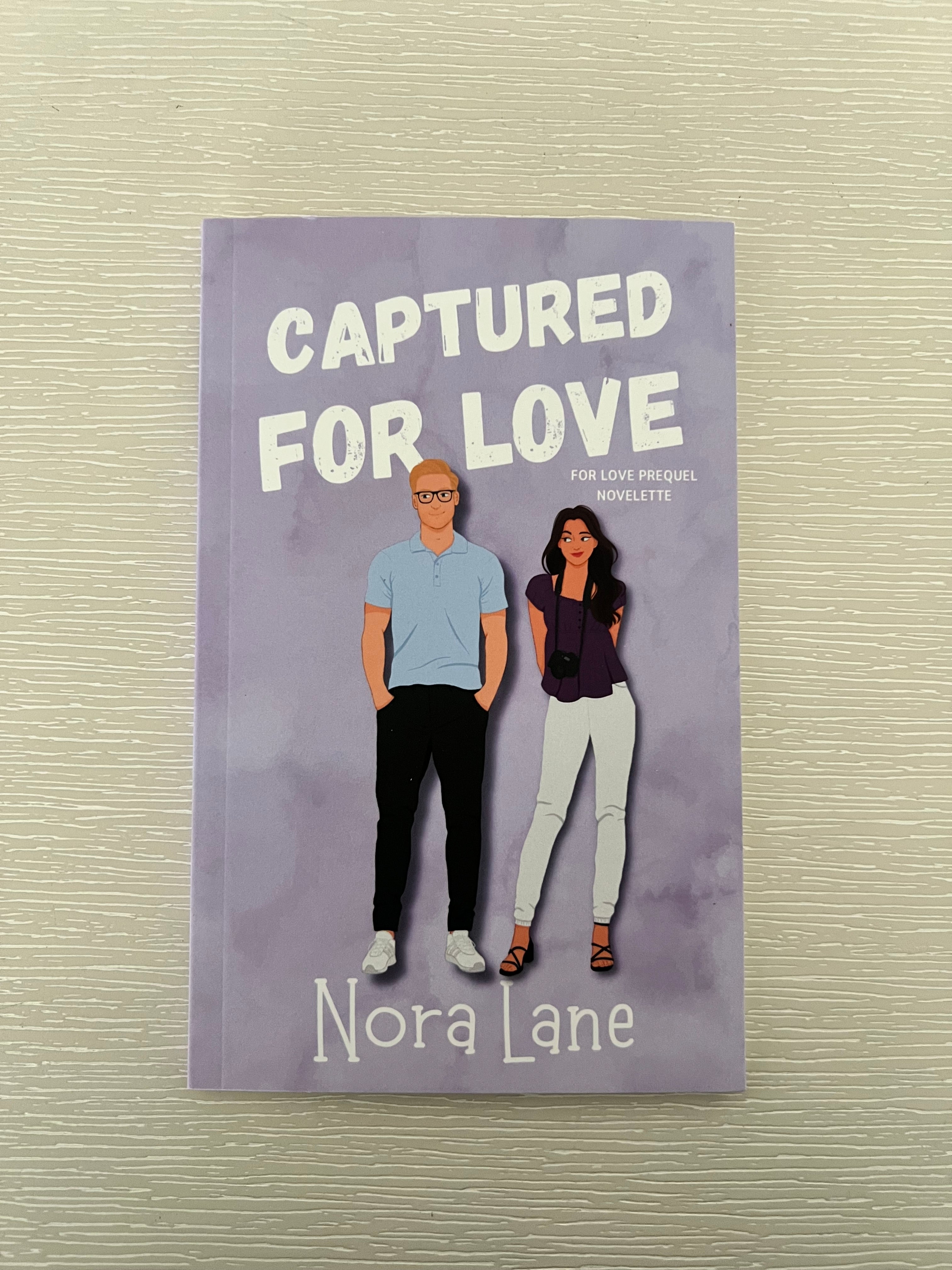Captured for love signed paperback novelette by Nora Lane with character art & swag